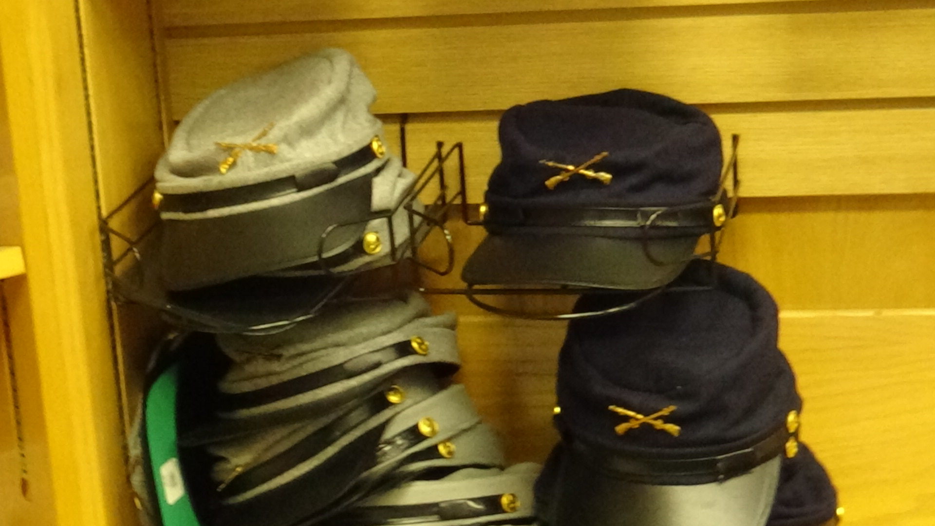 Civil war hats on display for sale in a store.