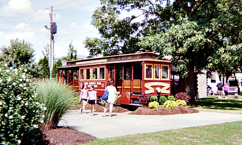 A mother using a mobile phone to take a picture of her two daughters at the Erie County Fair in Hamburg, New York.