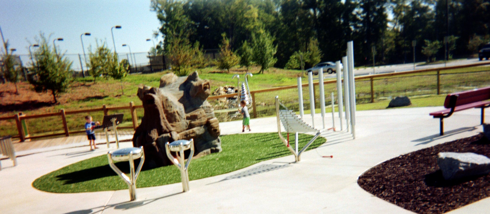 Kids playing musical instruments in a park.