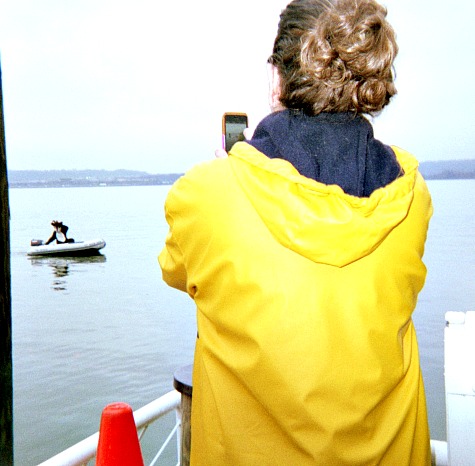 Woman using a mobile phone to take a picture.