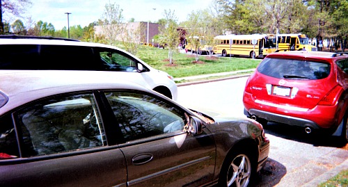 Parents in cars waiting to take their children home after school.
