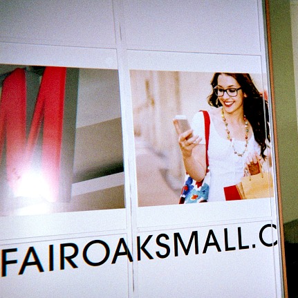 Adult personal page pictures a woman at a shopping mall holding a mobile phone.