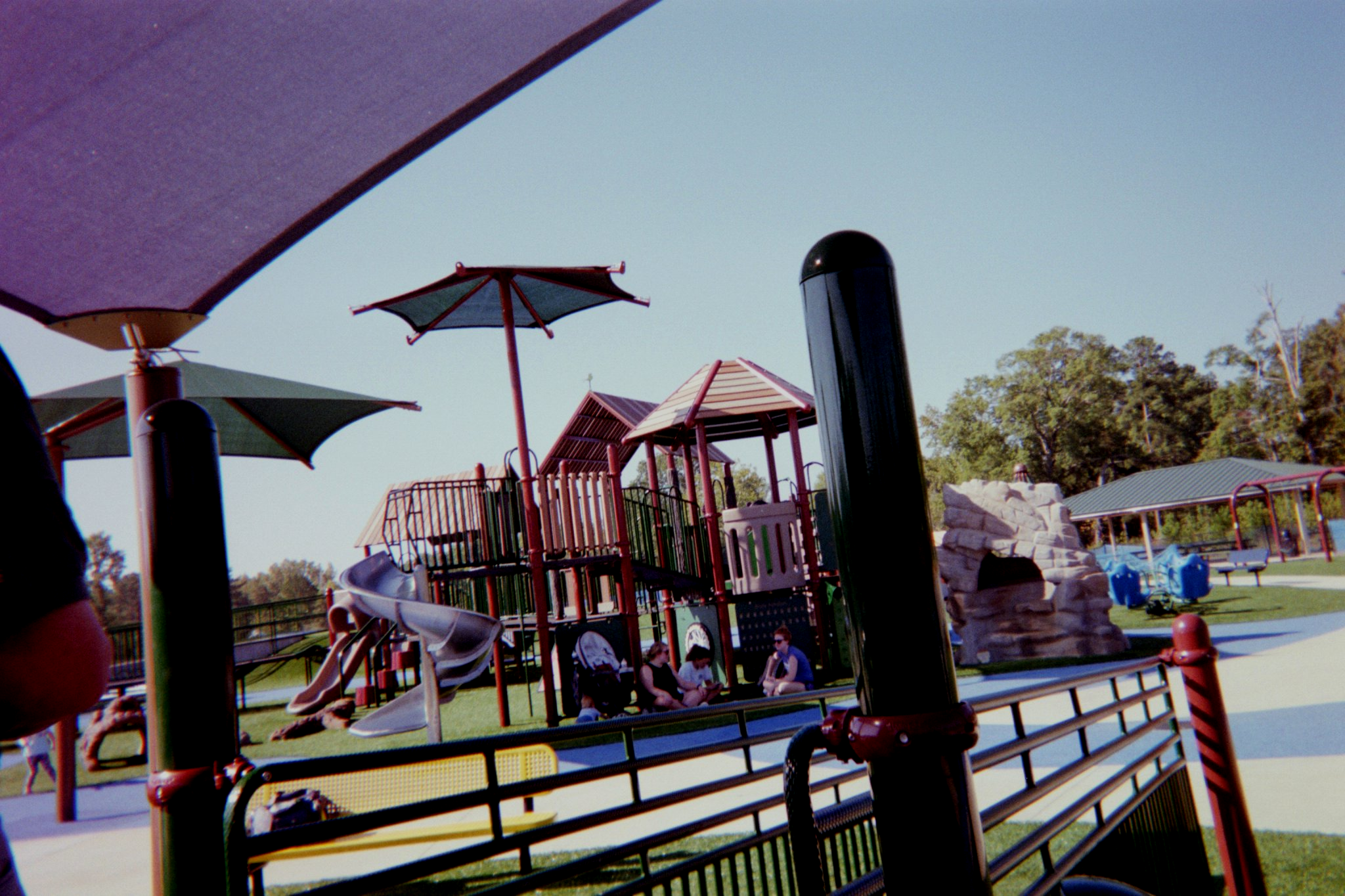 Mothers conversing with one another at a playground. Mothers conversing with one another at a playground.