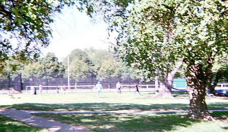 People playing sports in a park.