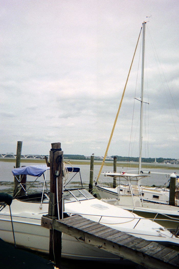 Tall mast on a boat in the water.