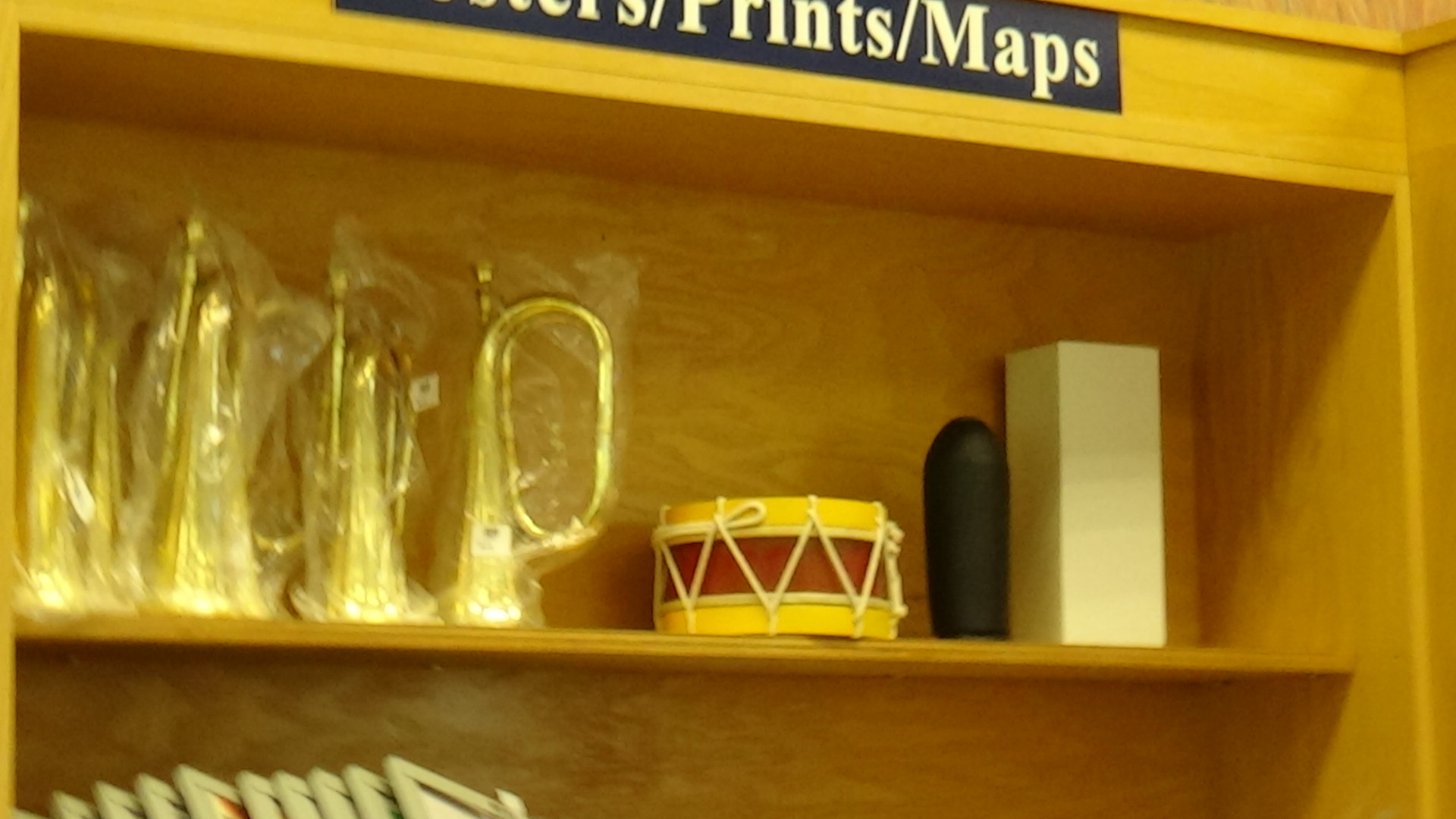 Bugles and drums on a shelf in collectible stores near me.