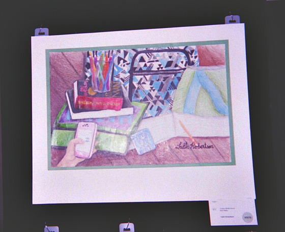 Student drawing of mobile phone and books.